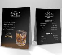 The front and back view of a black drink menu.