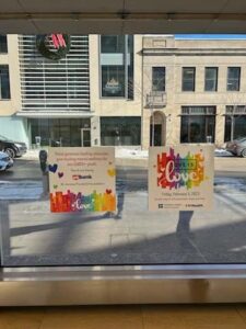 Two colorful window decals displaying rainbow colors.