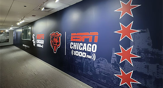 View down a hallway showing an ESPN Chicago banner.