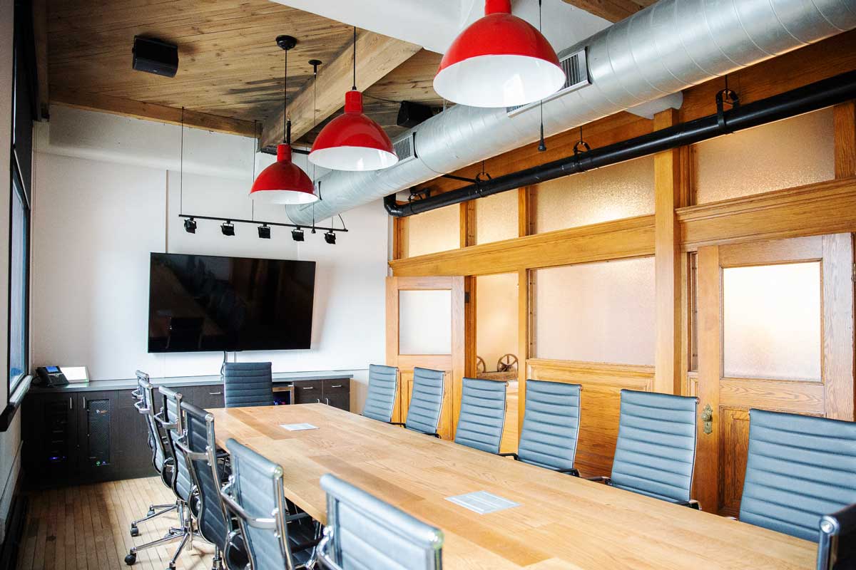 Bright office space with frosted window films and wood paneling.