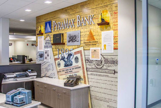 History wall collage at behind the front desk at PyraMax Bank.