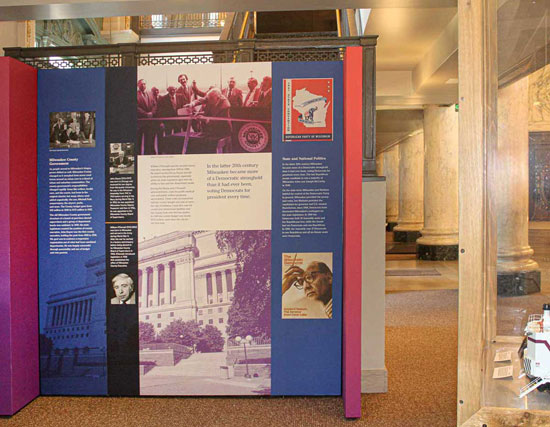 Blue, pink, and purple stand-up fabric display showing historical political information.