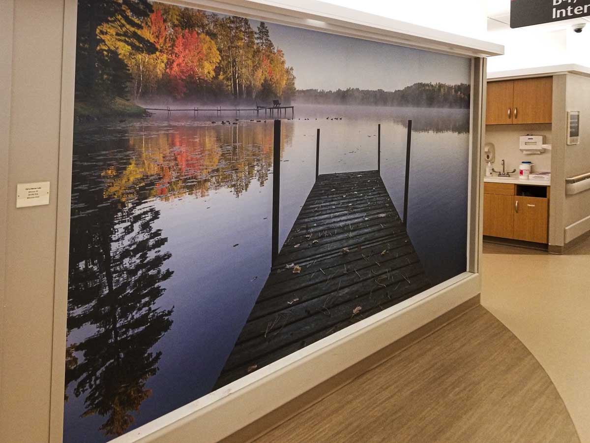 Adhesive wall fabric, displaying a scene of a dock over still water.